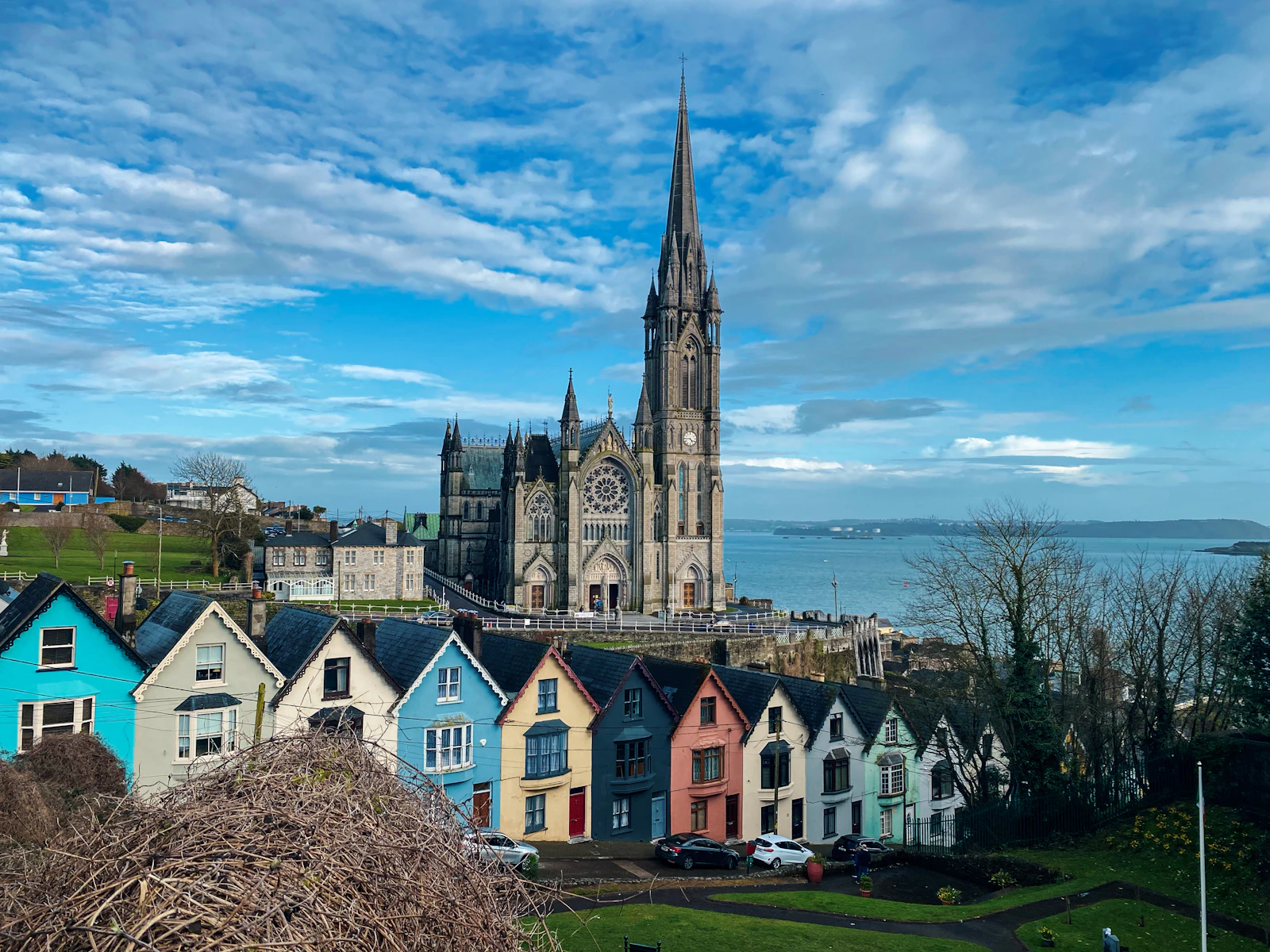 Casas de colores del frente marítimo de Cobh con la catedral de San Colmán al fondo